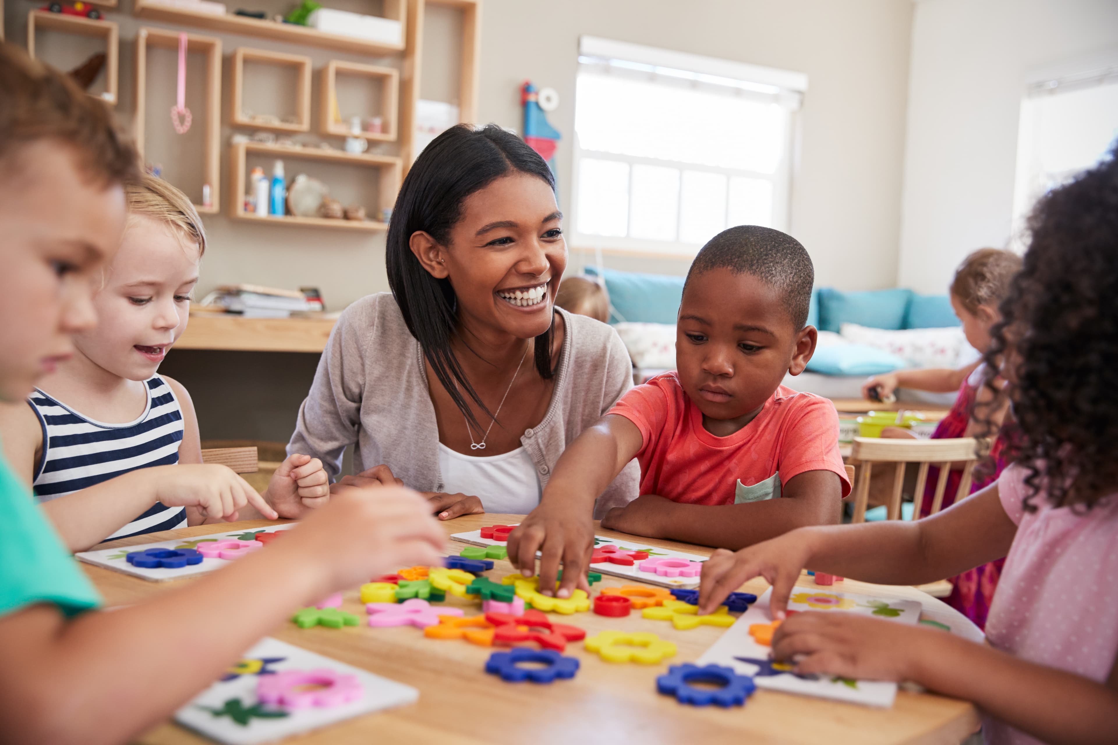 Teacher guiding children with hands-on Montessori learning materials
